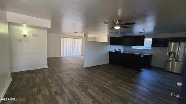 2908 N 53rd Ln, Phoenix, AZ 85031 - unfurnished living room with a ceiling fan, dark wood-type flooring, a sink, and baseboards