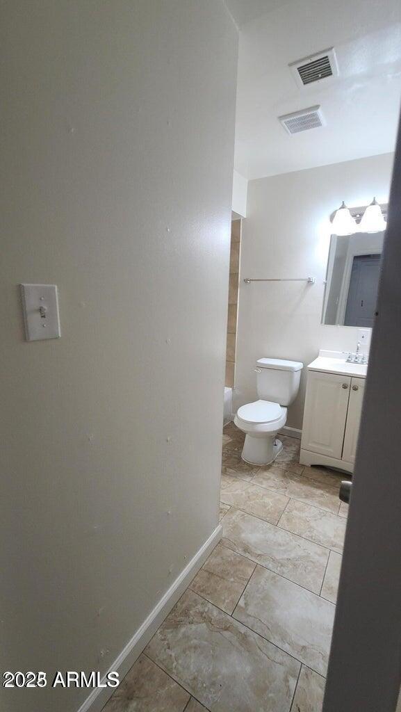 2908 N 53rd Ln, Phoenix, AZ 85031 - bathroom featuring vanity, toilet, and baseboards