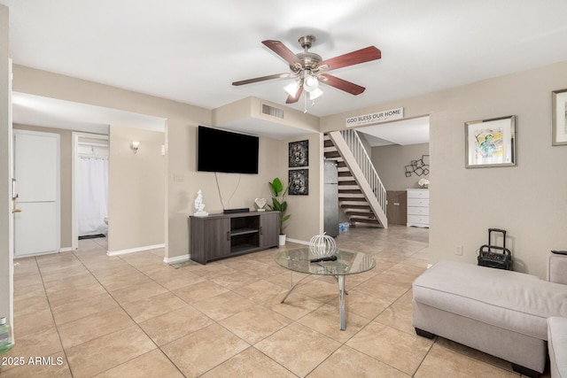 9028 W Osborn Rd, Phoenix, AZ 85037 - living room featuring baseboards, visible vents, a ceiling fan, stairway, and light tile patterned floors