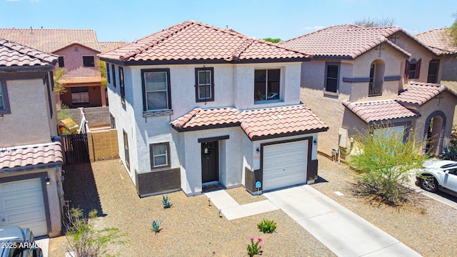 7712 S 64th Ln, Laveen, AZ 85339 - mediterranean / spanish home featuring stucco siding, driveway, a garage, and a tiled roof