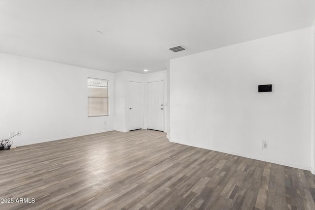 unfurnished room featuring hardwood / wood-style flooring