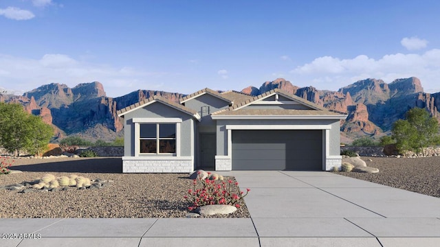 5496 E Axle Ln, San Tan Valley, AZ 85140 - ranch-style home with an attached garage, concrete driveway, a mountain view, stucco siding, and stone siding