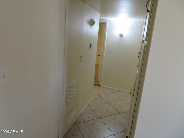 hall featuring light tile patterned flooring