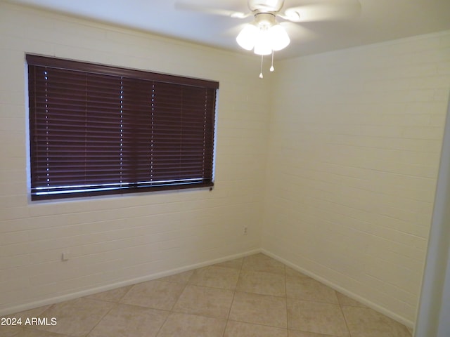 spare room with light tile patterned floors and ceiling fan