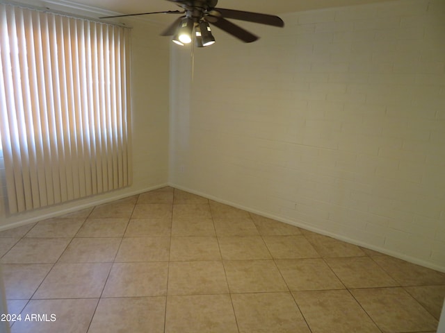 unfurnished room featuring light tile patterned floors and ceiling fan