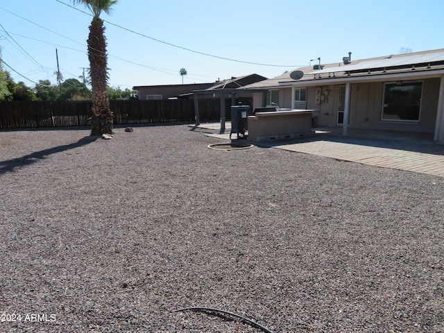 view of yard with a hot tub and a patio area