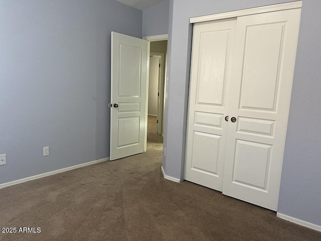 3876 Camino Del Vara, Sierra Vista, AZ 85650 - unfurnished bedroom with dark carpet, a closet, and baseboards