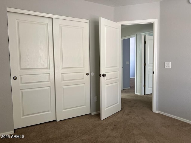 3876 Camino Del Vara, Sierra Vista, AZ 85650 - unfurnished bedroom with dark colored carpet, a closet, and baseboards