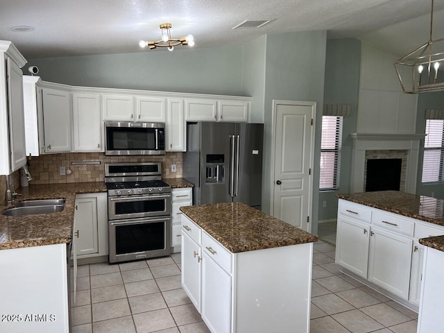 3876 Camino Del Vara, Sierra Vista, AZ 85650 - kitchen featuring appliances with stainless steel finishes, a chandelier, a sink, light tile patterned floors, and high vaulted ceiling