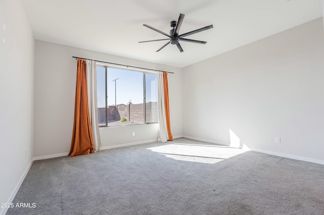 spare room featuring baseboards, carpet floors, and a ceiling fan