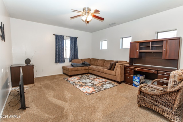 carpeted living room with ceiling fan