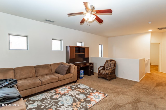 living room featuring light colored carpet and ceiling fan