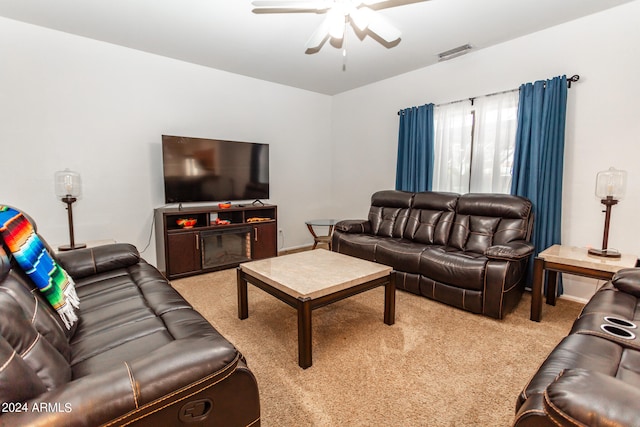 carpeted living room featuring ceiling fan