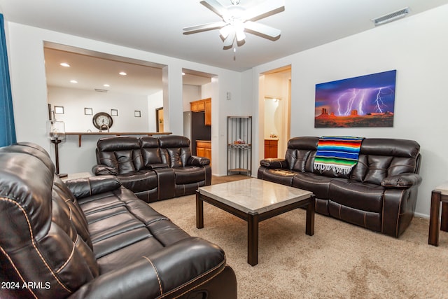 living room with light carpet and ceiling fan