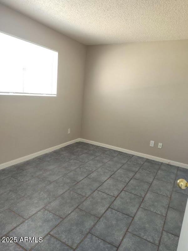 755 E Millett Ave, Mesa, AZ 85204 - empty room with a textured ceiling and baseboards