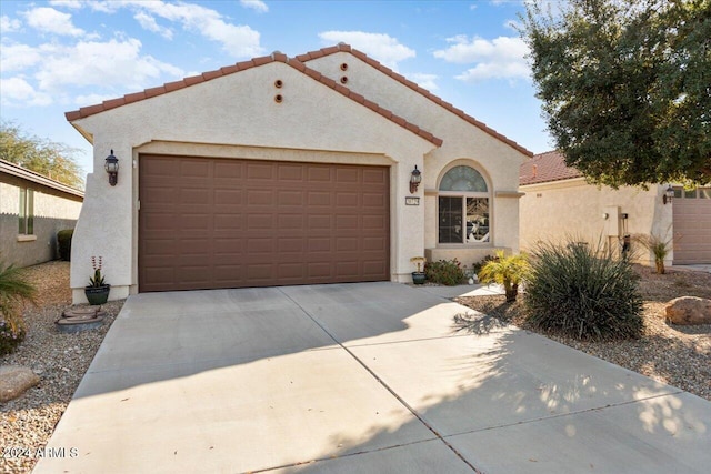 mediterranean / spanish house with a garage