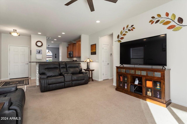 living room with ceiling fan and light carpet