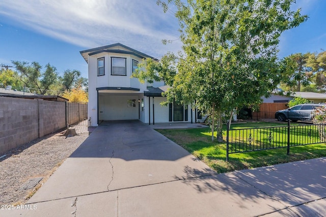 view of front of home featuring a fenced front yard, driveway, and a front lawn