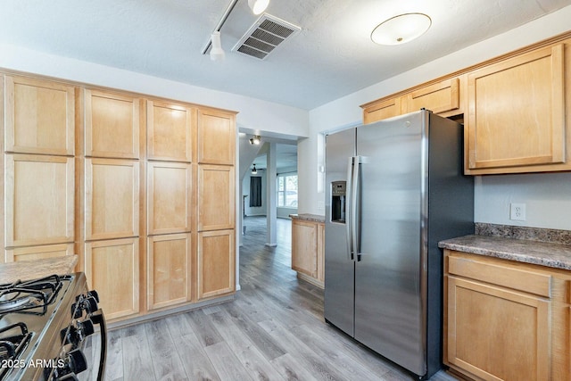 kitchen with light wood-style flooring, light brown cabinets, visible vents, and stainless steel appliances