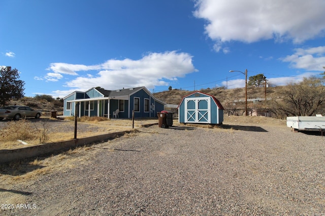 view of front facade featuring a storage shed