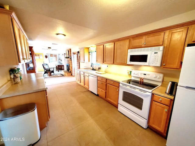 kitchen featuring white appliances and sink