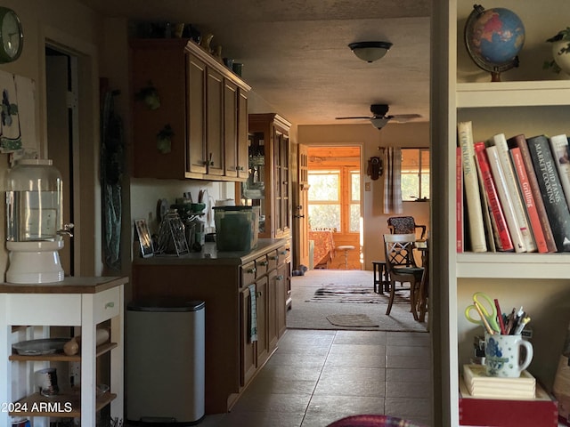 kitchen featuring built in shelves and ceiling fan