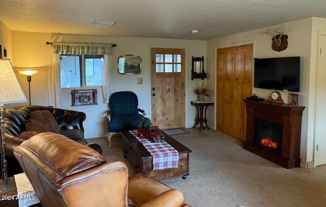 living room featuring plenty of natural light, carpet floors, and a textured ceiling