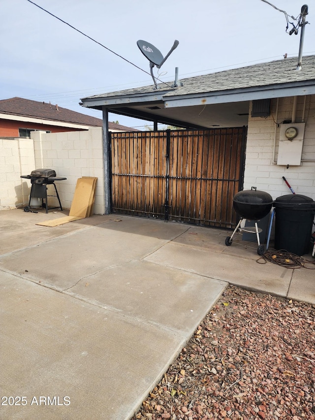 view of patio featuring area for grilling and fence