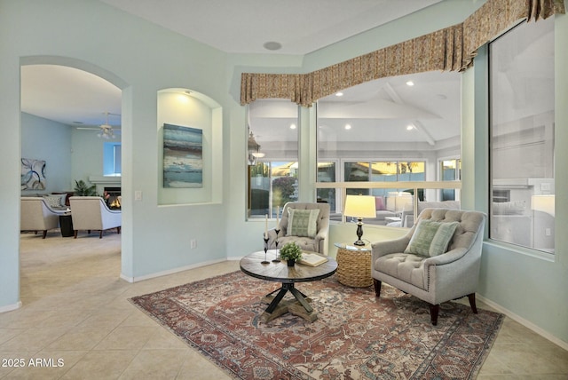 sitting room featuring light tile patterned floors and ceiling fan