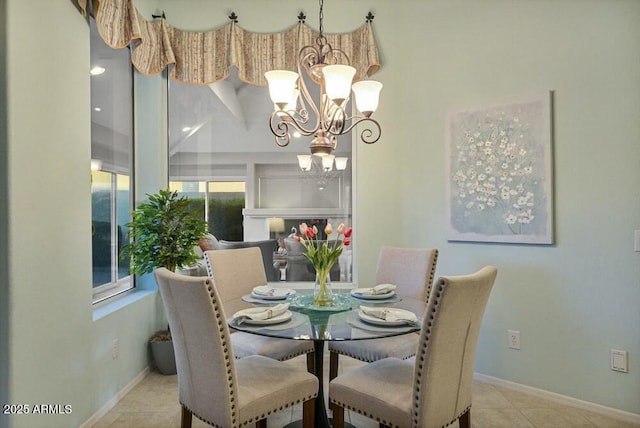 tiled dining area with an inviting chandelier