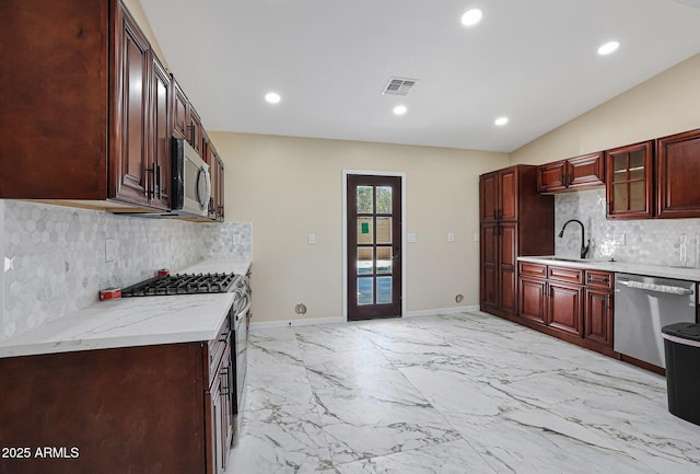kitchen featuring a sink, reddish brown cabinets, appliances with stainless steel finishes, and recessed lighting