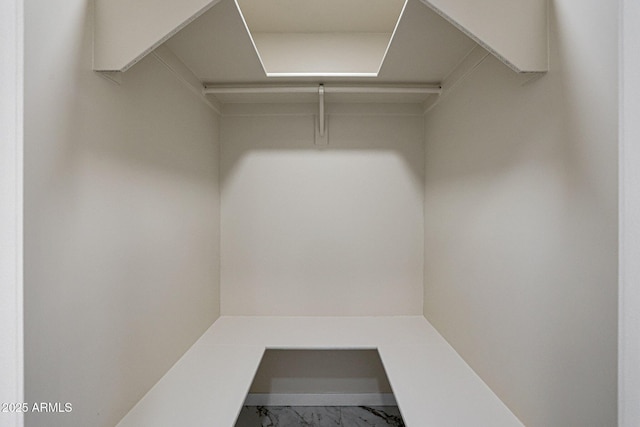 spacious closet featuring marble finish floor