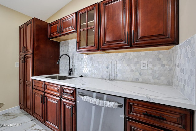 kitchen with stainless steel dishwasher, tasteful backsplash, light stone counters, marble finish floor, and a sink