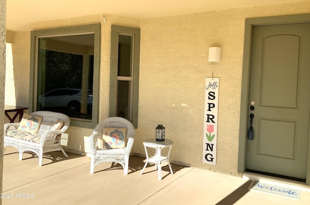 view of exterior entry featuring stucco siding