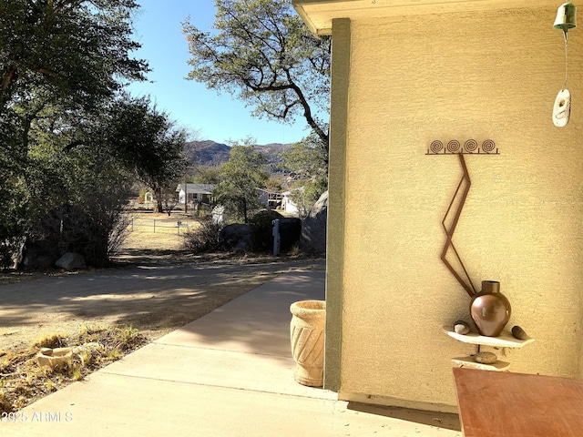 details featuring stucco siding and a mountain view