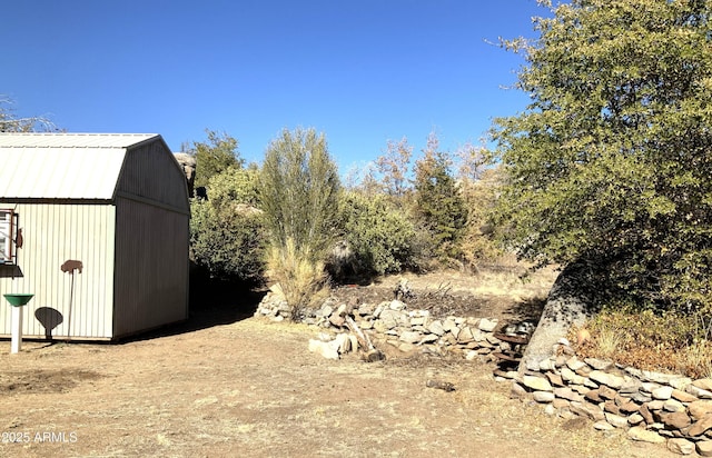 view of yard featuring an outbuilding and a shed