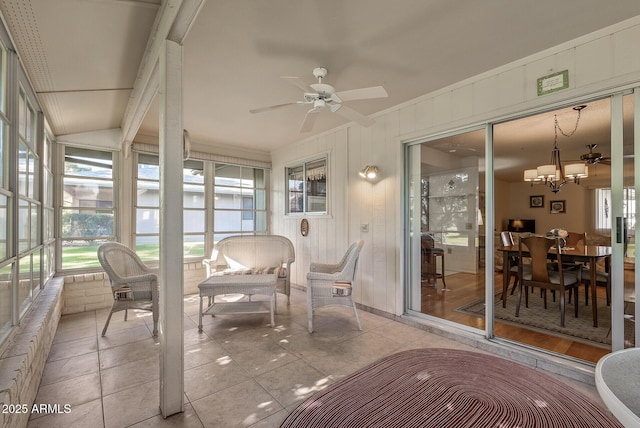 sunroom / solarium with ceiling fan with notable chandelier