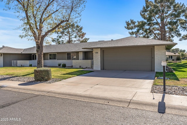 single story home featuring a garage and a front lawn