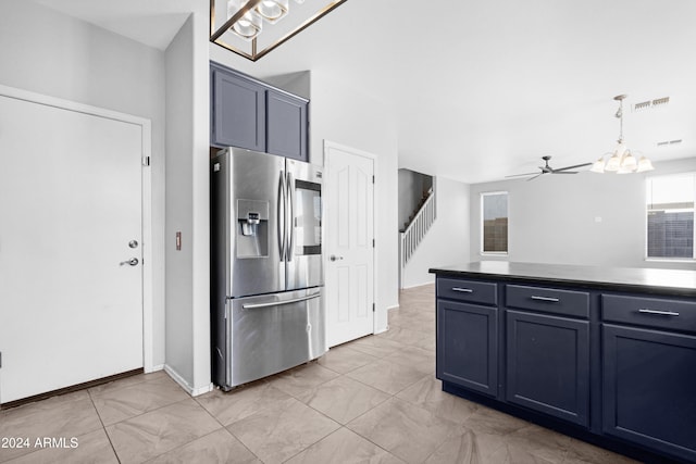 kitchen with stainless steel refrigerator with ice dispenser, ceiling fan with notable chandelier, pendant lighting, and blue cabinets