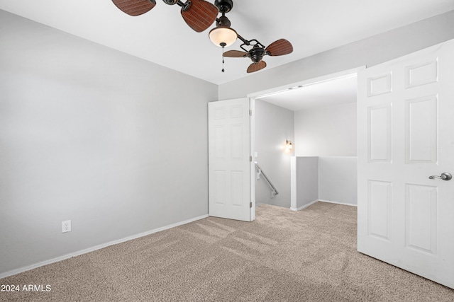 carpeted spare room with ceiling fan