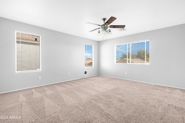 unfurnished room featuring ceiling fan and carpet