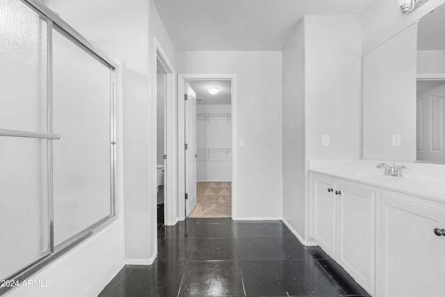 bathroom featuring shower / bath combination with glass door, tile patterned floors, and vanity