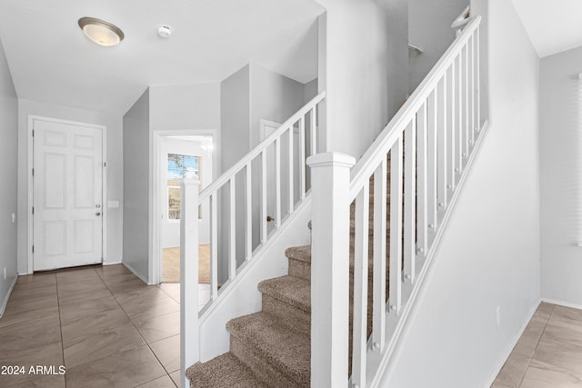 stairs featuring tile patterned flooring