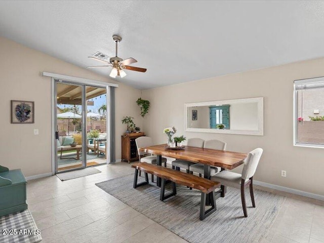 dining space with baseboards, plenty of natural light, ceiling fan, and lofted ceiling