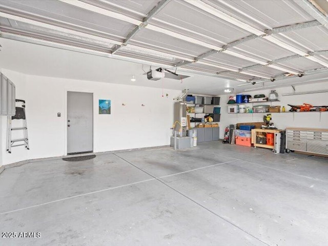 garage with a workshop area and a garage door opener