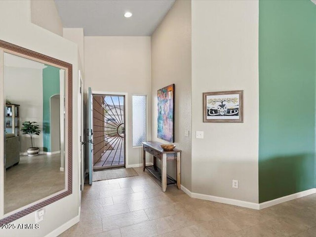 entryway featuring baseboards and light tile patterned floors