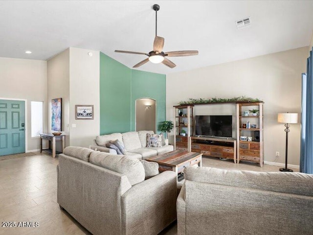 living area featuring ceiling fan, visible vents, and baseboards