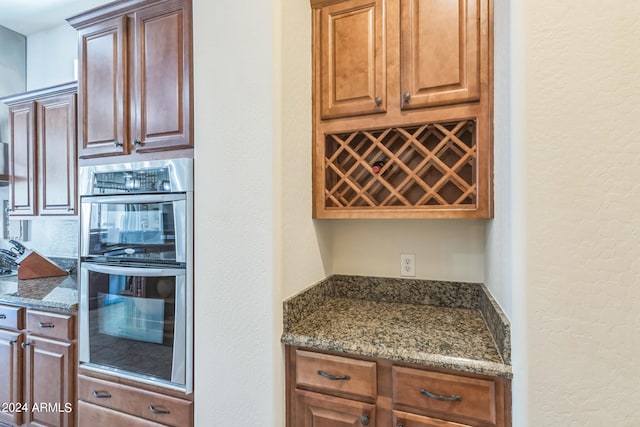 kitchen featuring dark stone countertops and double oven