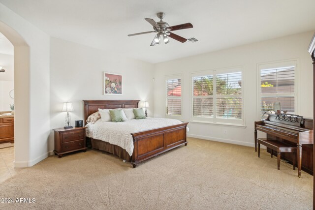 bedroom with ceiling fan and light colored carpet