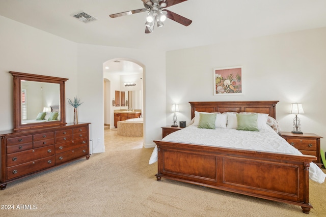 carpeted bedroom featuring ceiling fan and connected bathroom